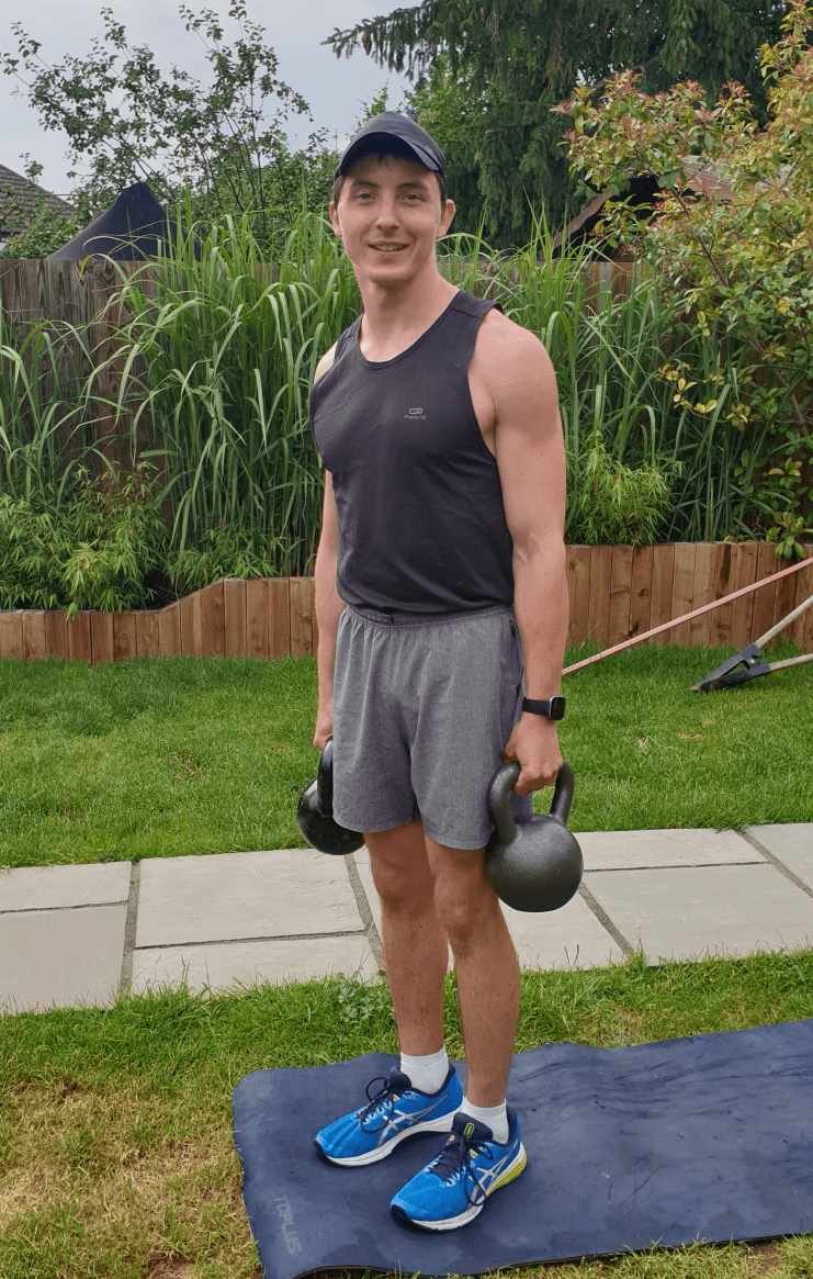 Luke holding two kettlebells